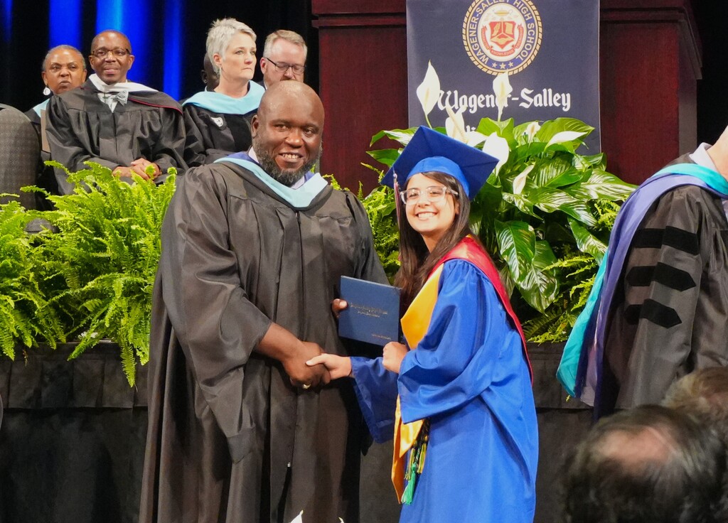 Rasheem Neloms, Principal, with a WSHS graduate. 