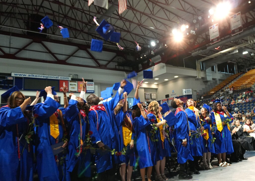 WSHS students through their caps after graduation. 