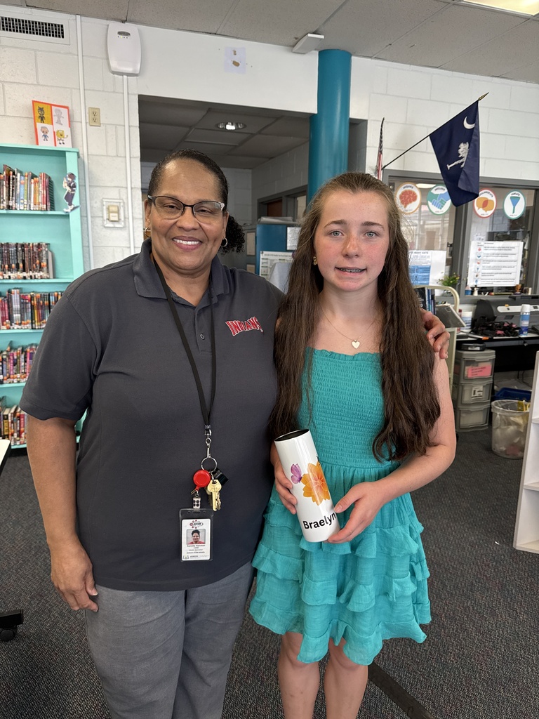 Student with librarian displaying her customized sublimated cup.