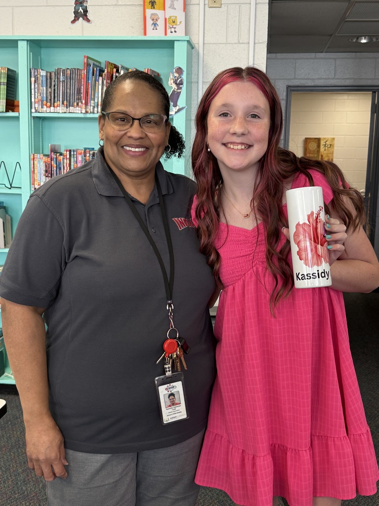 Student with librarian displaying her sublimated cup.