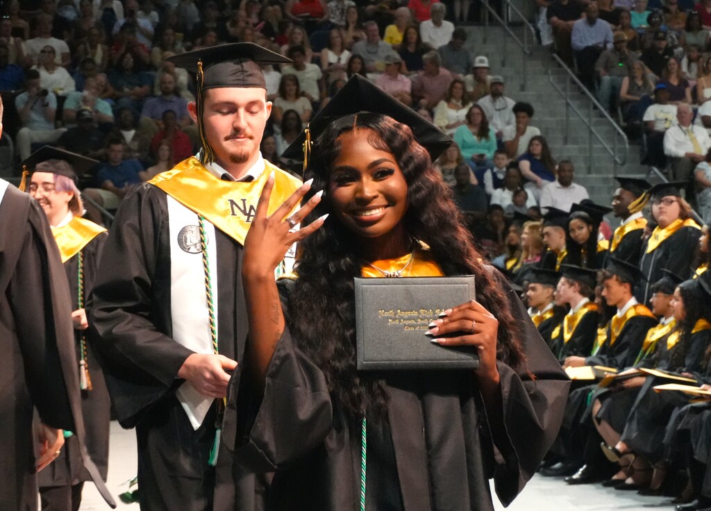 NAHS female student posing with her diploma. 