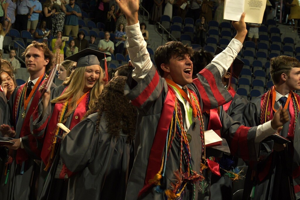 A group of ASA students celebrate after graduation. 