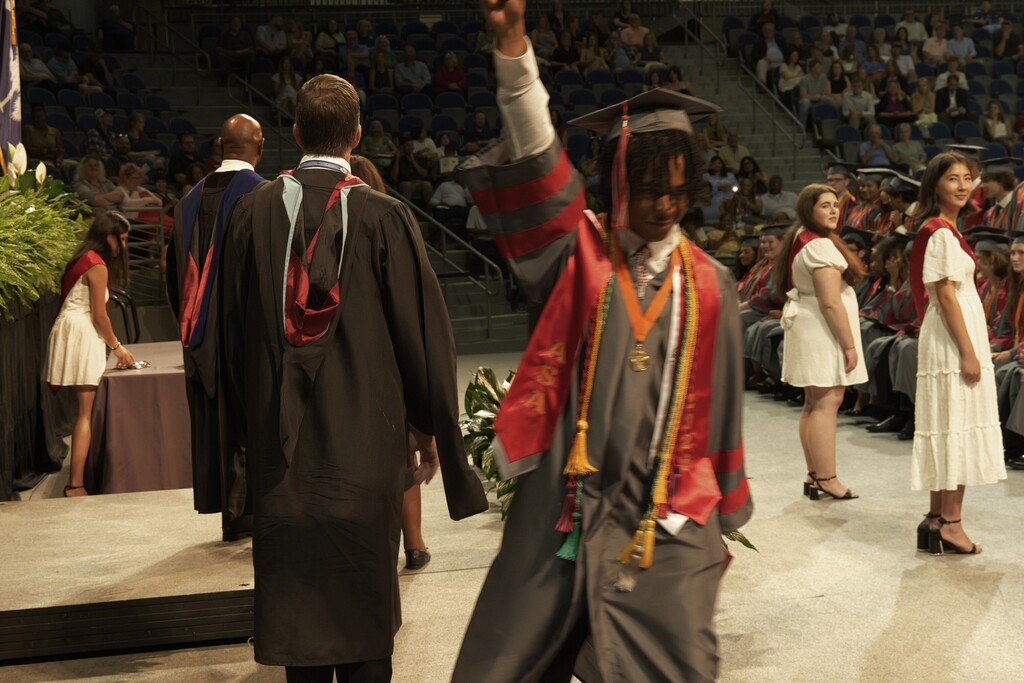 Male ASA graduate celebrates after receiving his diploma. 