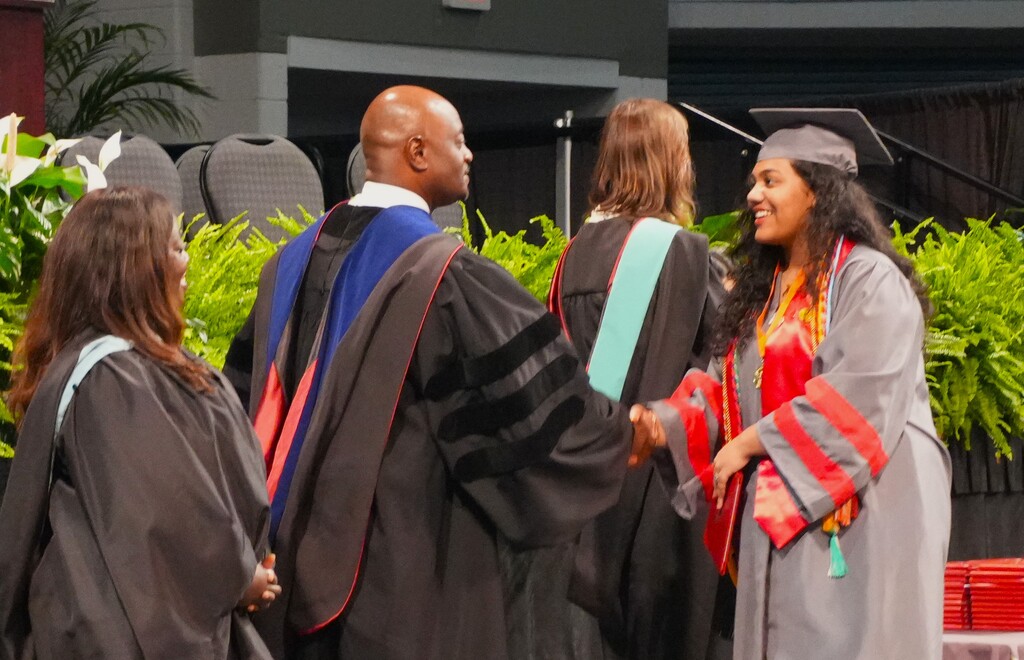 ASA female graduate shakes the hand of superintendent Corey Murphy. 