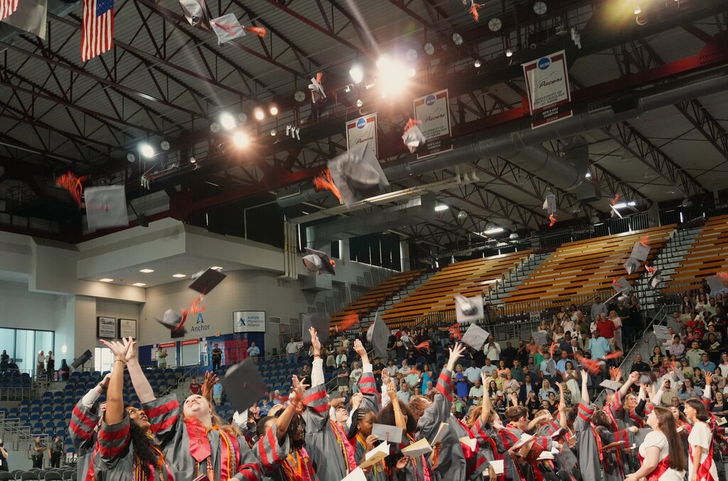 ASA students toss their caps at the end of the ceremony. 