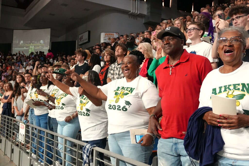 Parents of Aiken High graduates cheer in.
