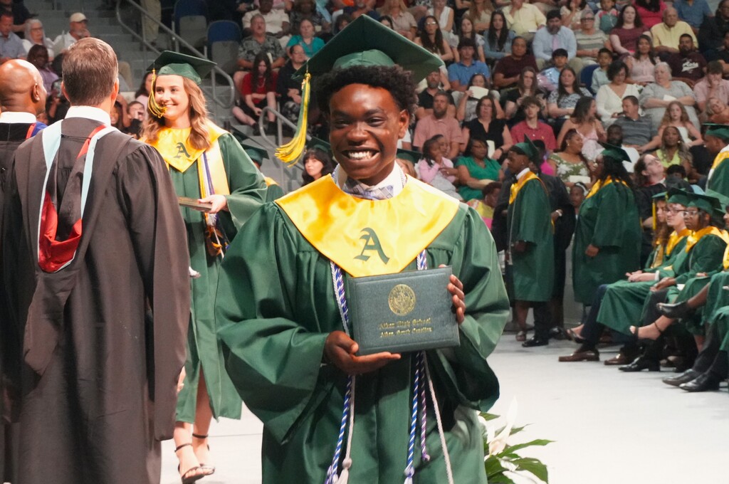An Aiken High graduate showcases his diploma.