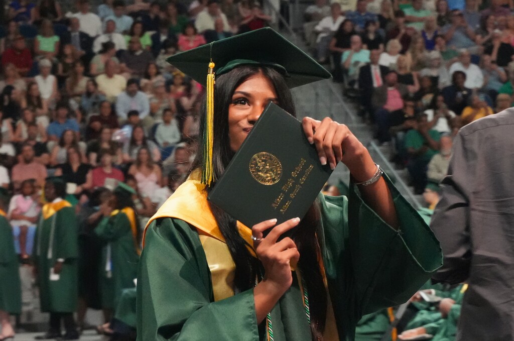 An Aiken High graduate showcases her diploma.