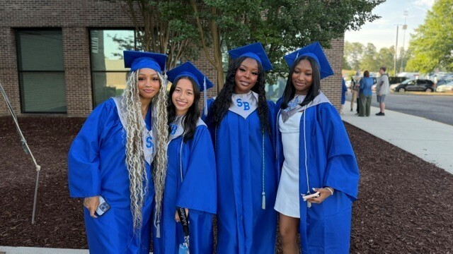 Graduates prosing for a picture before graduation.