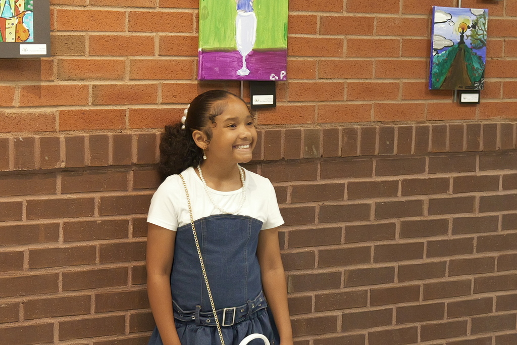 acGATEWAY student poses in front of her artwork.