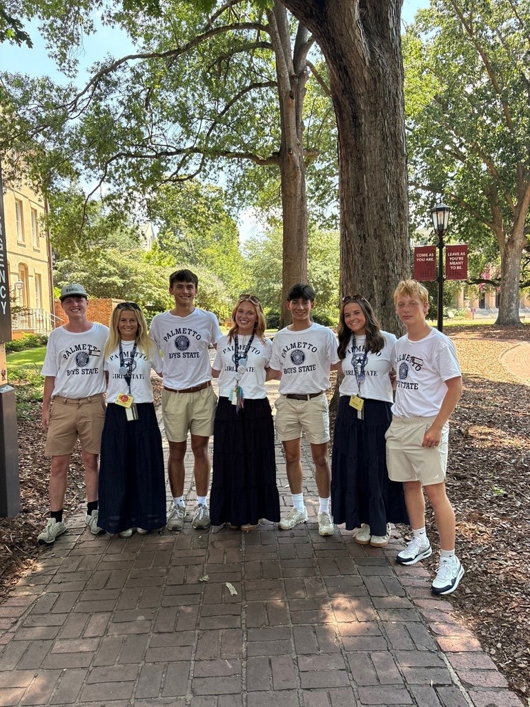 Students with Palmetto Girls State and Boys State Shirts on brick walkway with trees.