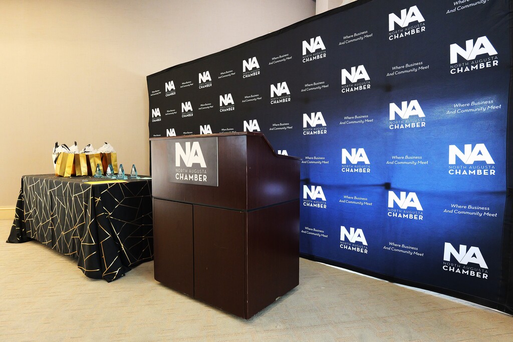 Shot of the North Augusta Chambers photo backdrop, and the NA Chambers podium.
