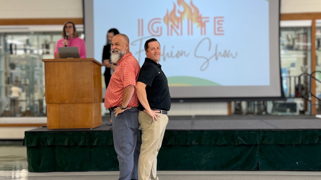 Principals from MVHS and NAHS standing back-to-back while showcasing appropriate dress code clothes.