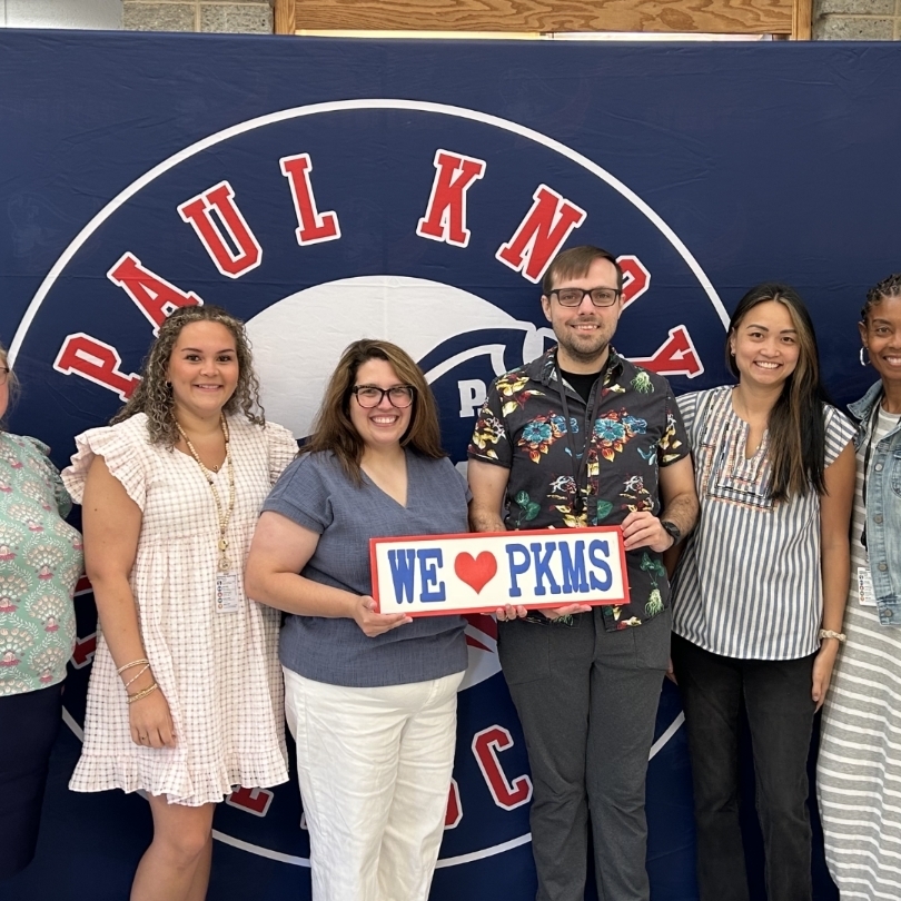 teachers holding "I love PKMS" sign