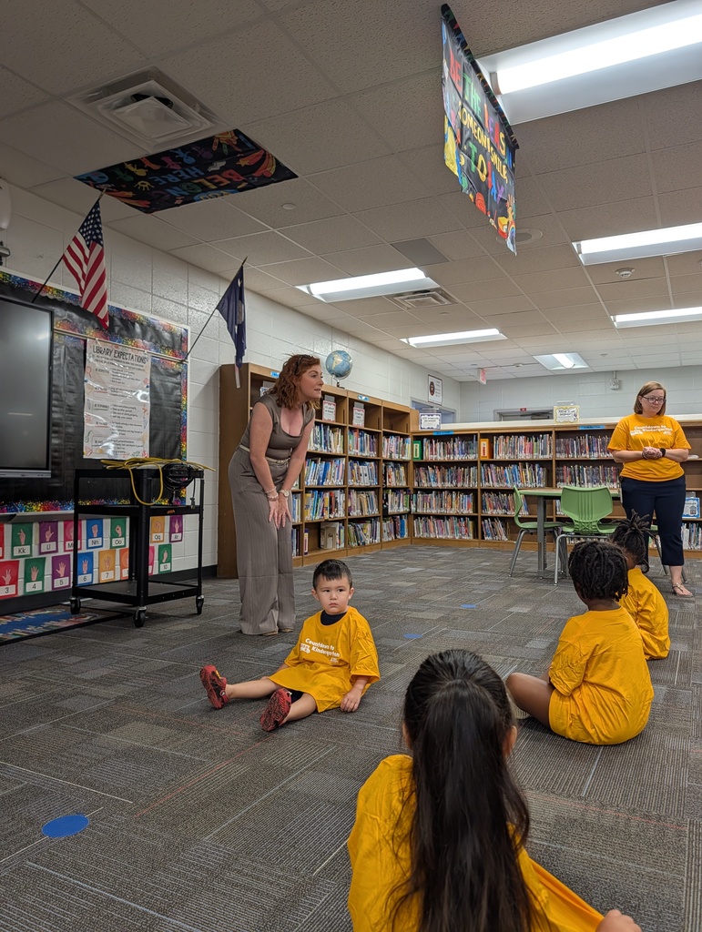 Teacher leads students seated on the classroom floor at Redcliffe Elementary.