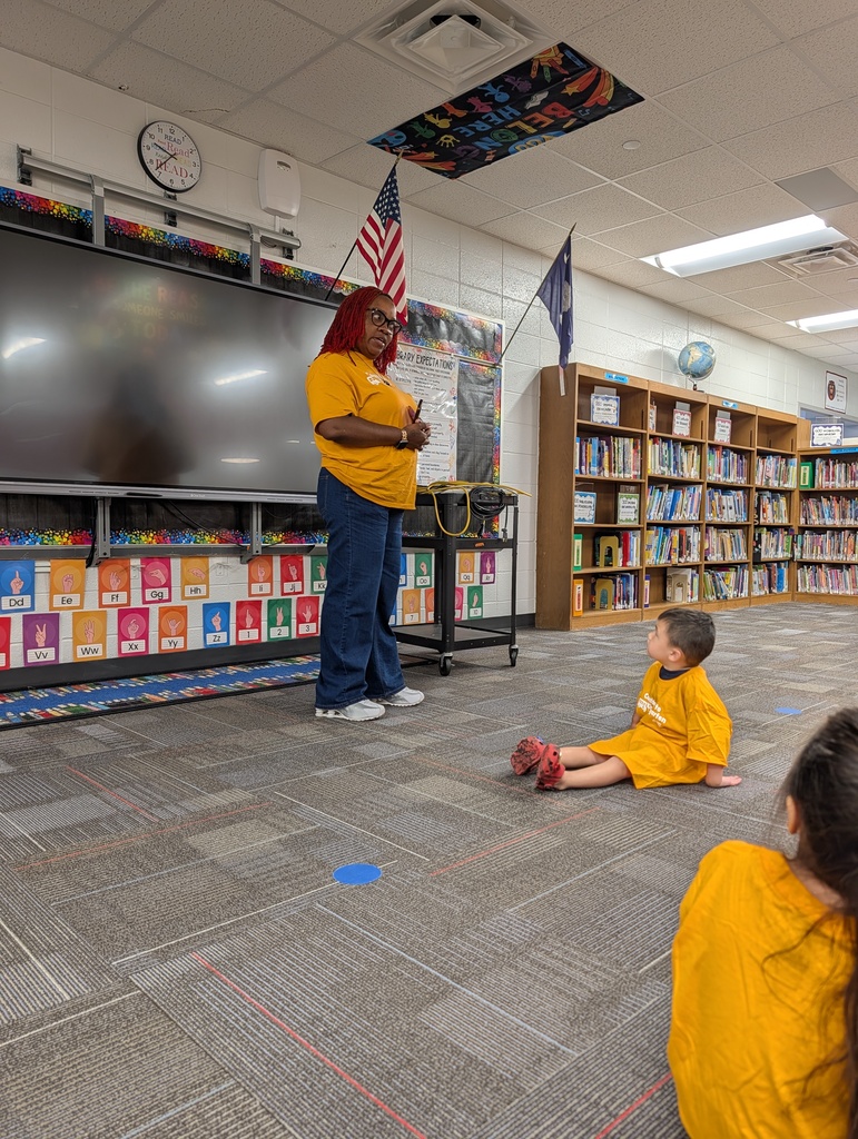 Teacher leads students seated on the classroom floor at Redcliffe Elementary.