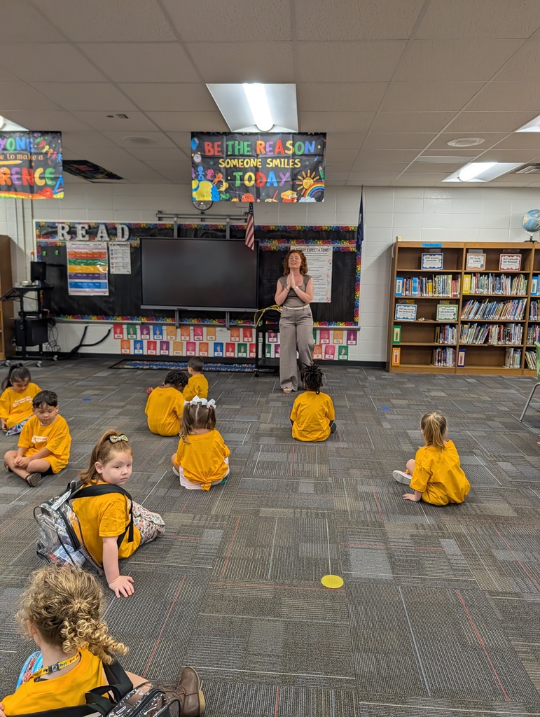 Teacher leads students seated on the classroom floor at Redcliffe Elementary.