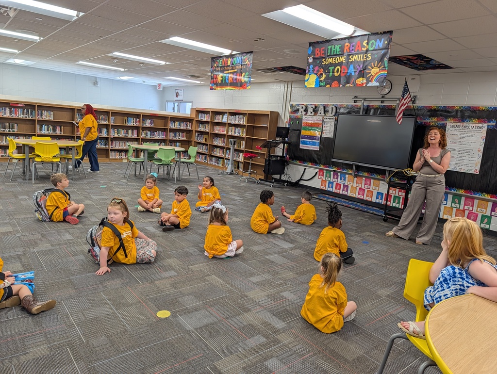 Teacher leads students seated on the classroom floor at Redcliffe Elementary.