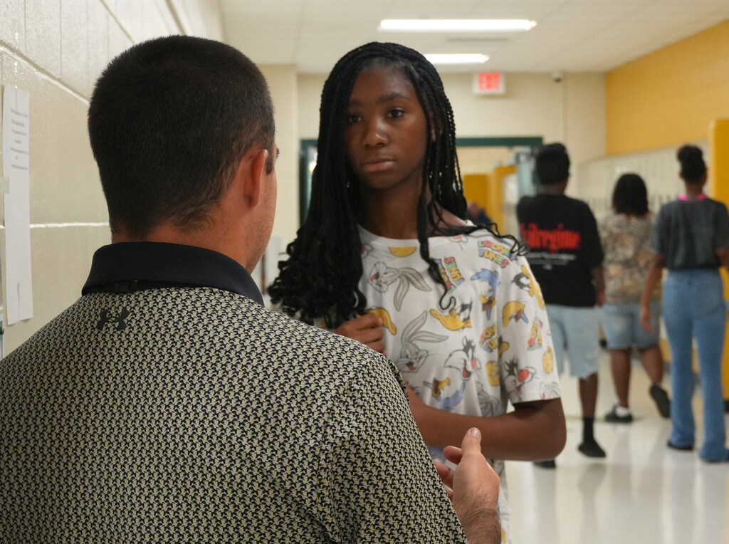 A student at Aiken High School speaks to her teacher.