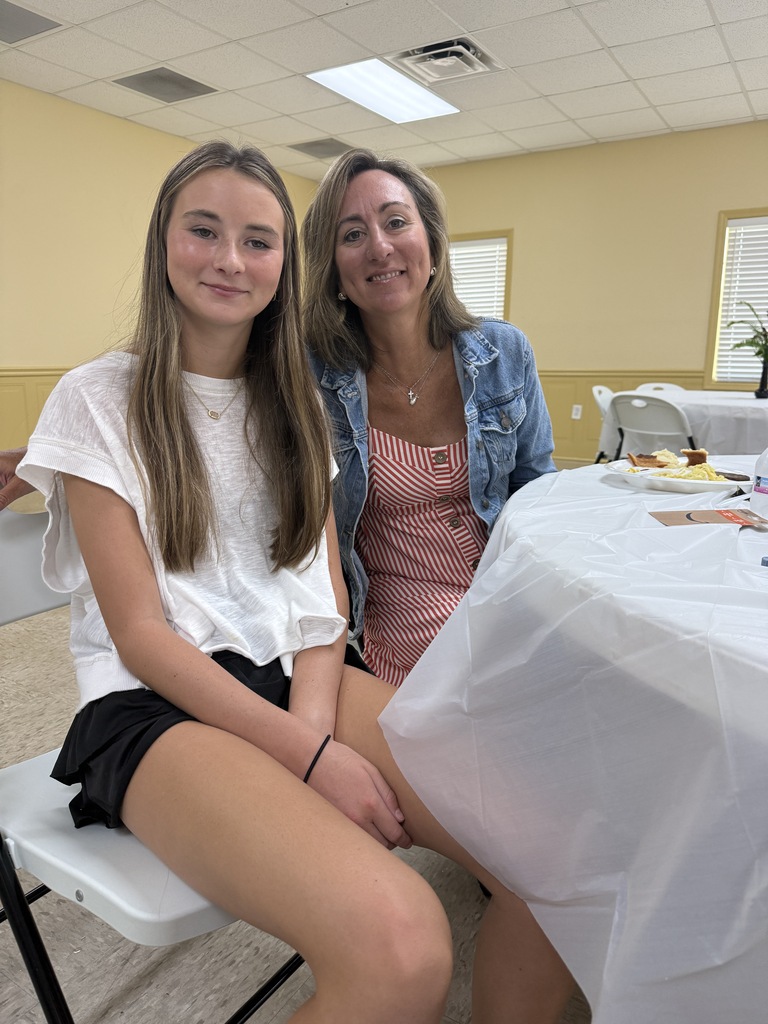 two people sitting and smiling for a picture