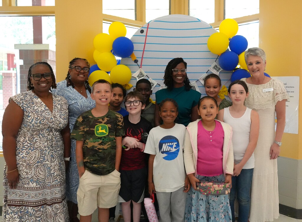 North Aiken Elementary students and administrators smile with Dr. Amy Edwards.