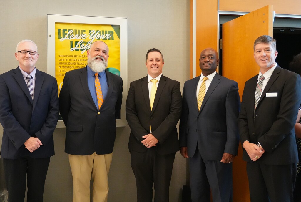 District leadership and school principals pose for a photo.