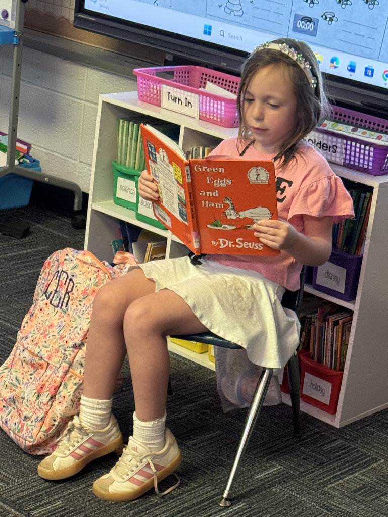 First Grade student reading to class
