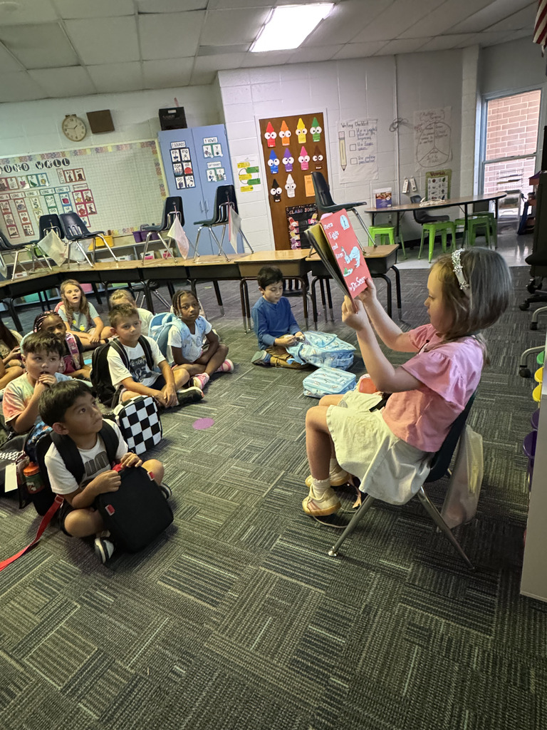 First Grade student reading to class