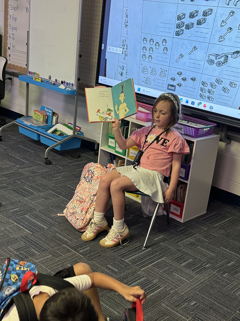 First Grade student reading to class