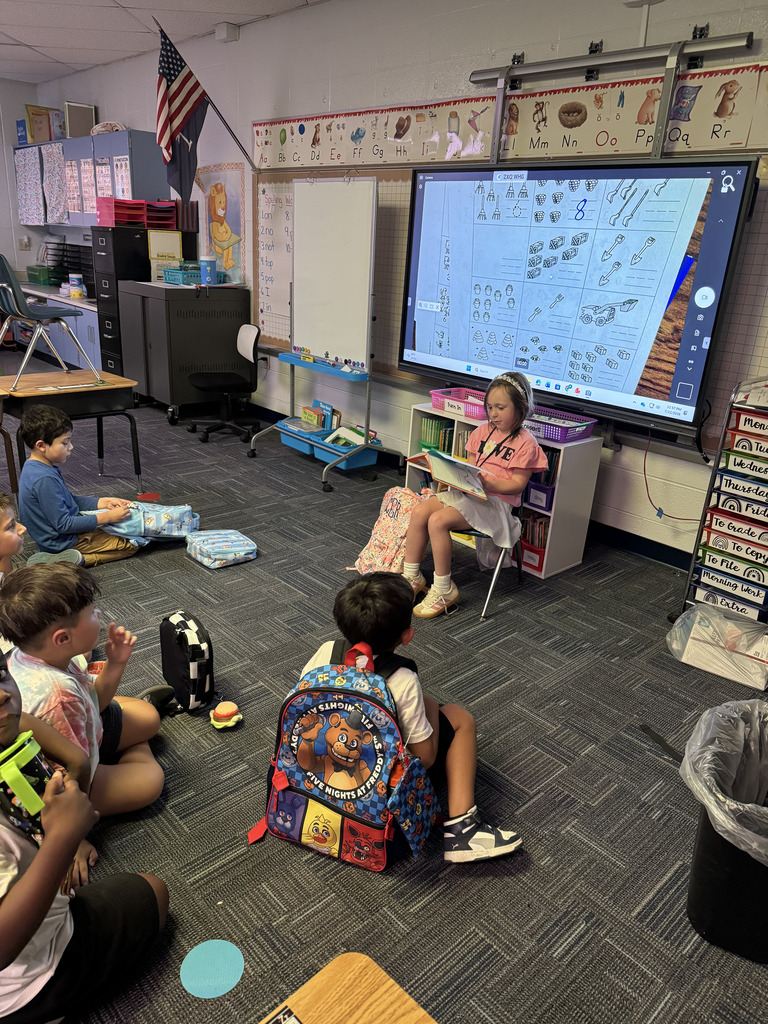First Grade student reading to class