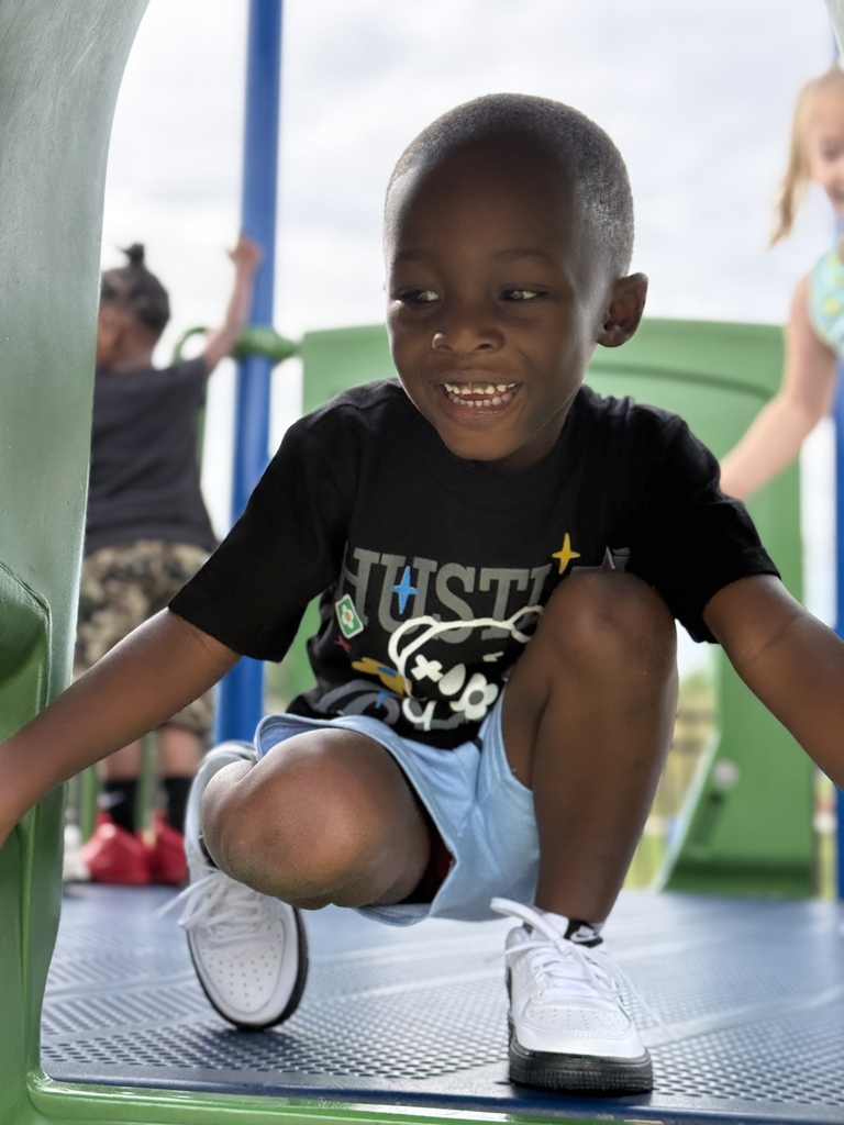 Image of young student on playground equipment
