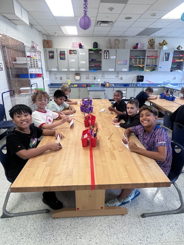 Student sitting at a table in art class
