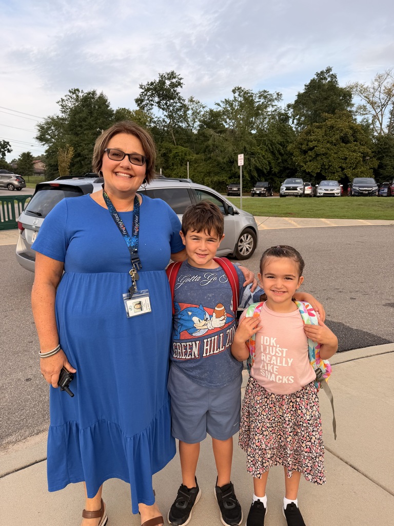 Image of the Principal of Graniteville ELementary and 2 children. ALl are smiling. 
