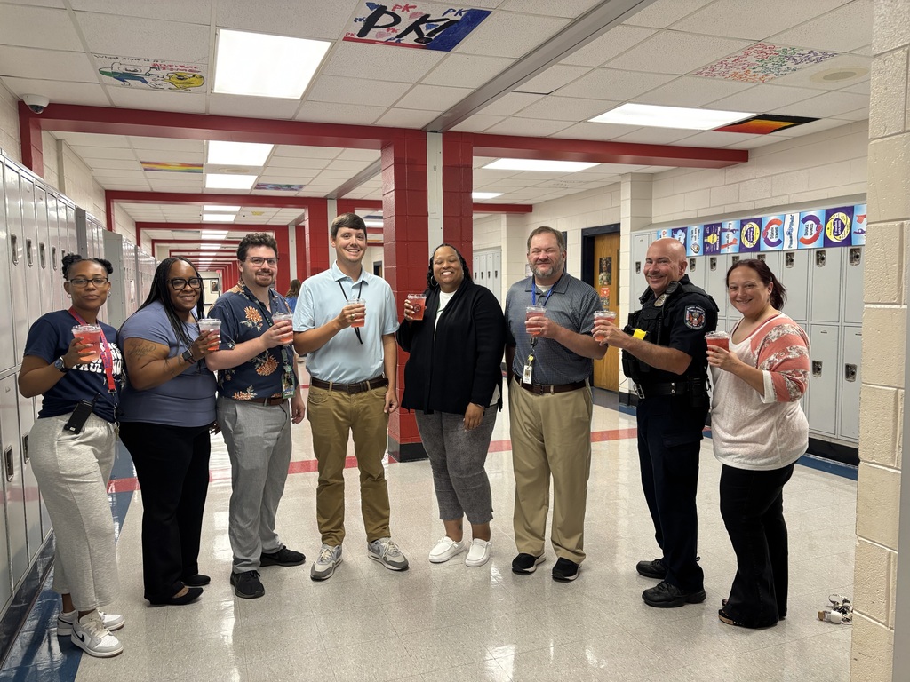 group of teachers holding 7 brew refreshers in a school hallway