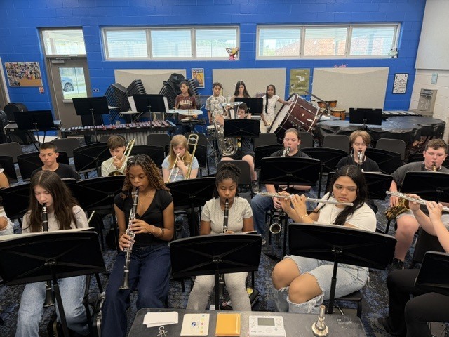Students in band class rehearsing music