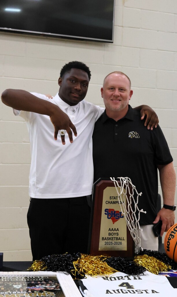 Player and coach showing off ring. 
