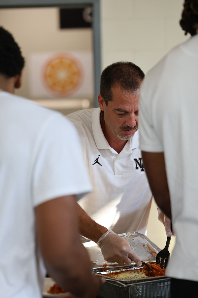 Coach serving food. 
