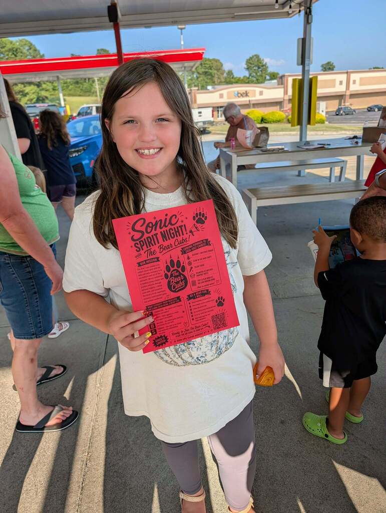 Girl holding sign.