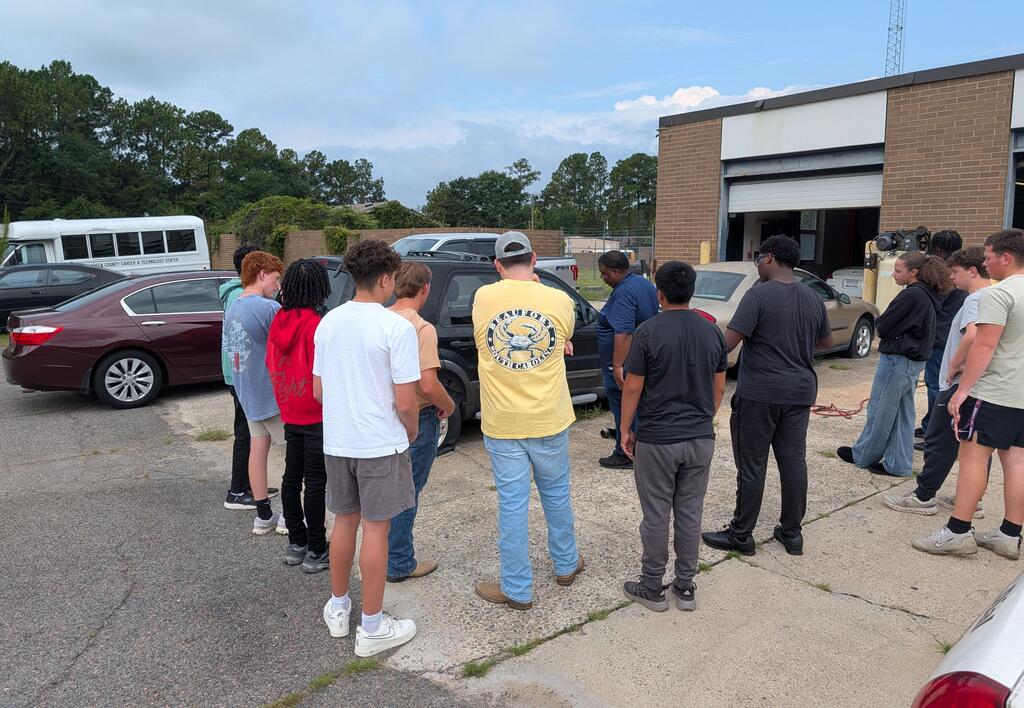 student learn how to jack up a vehicle