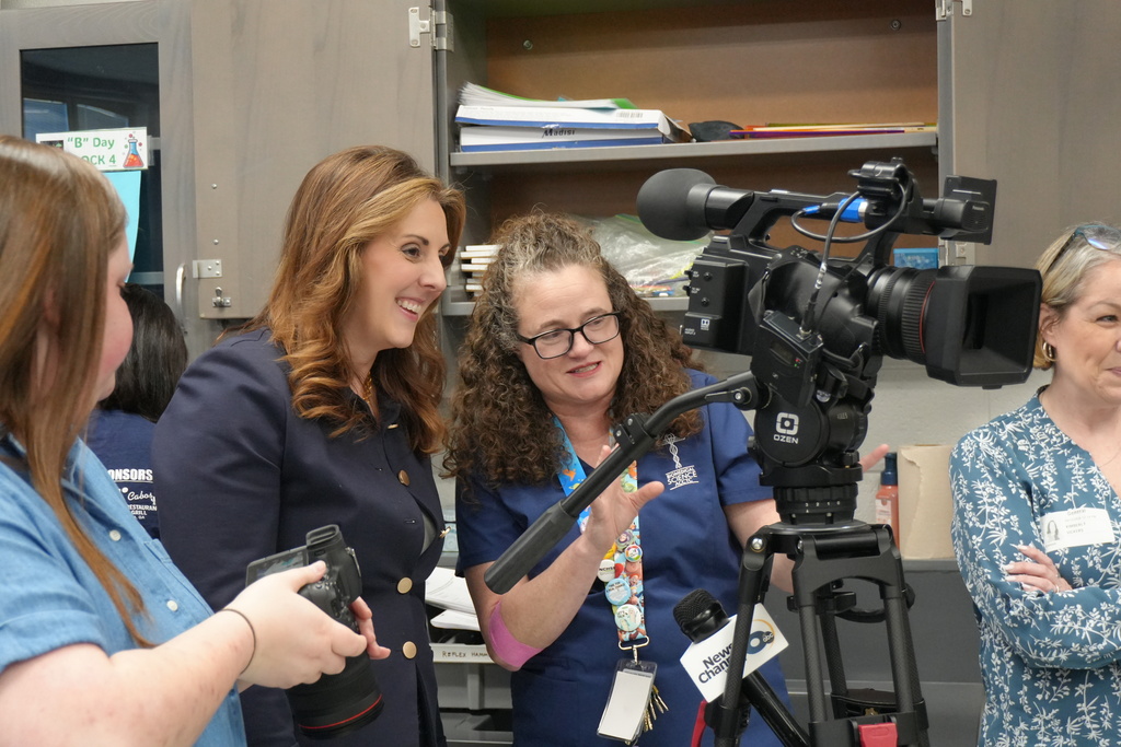 Dr. Palladino standing behind a camera post news interview.