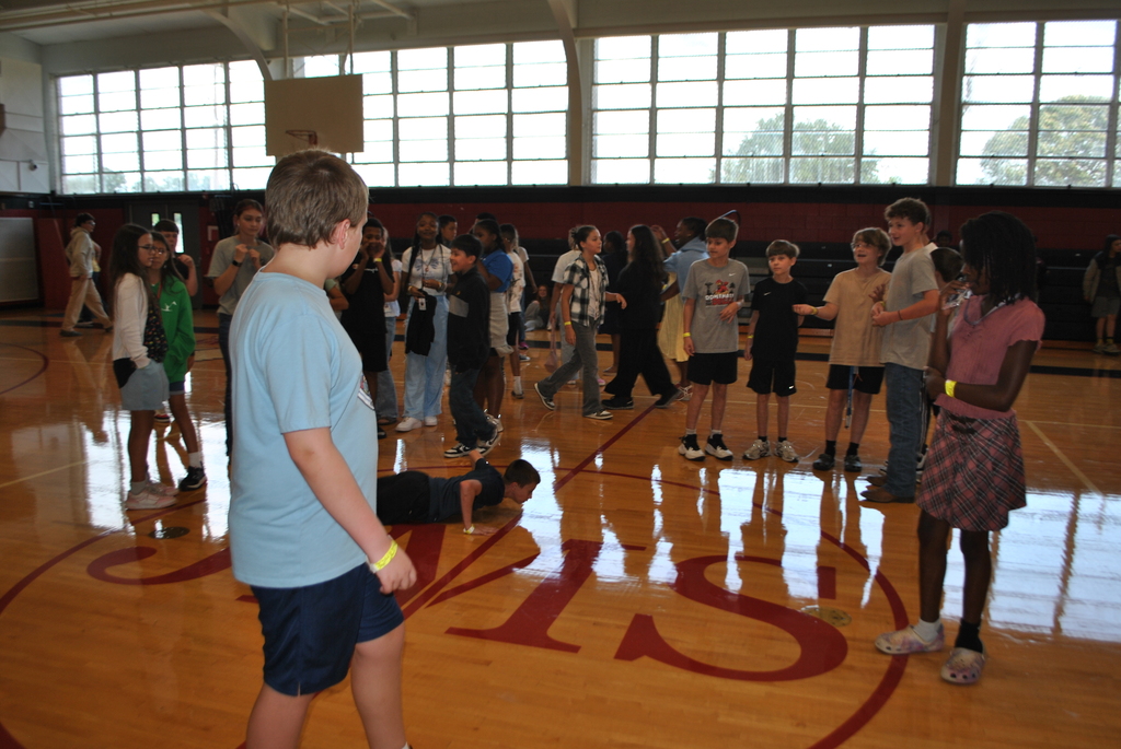 Scholars watching a student dance.