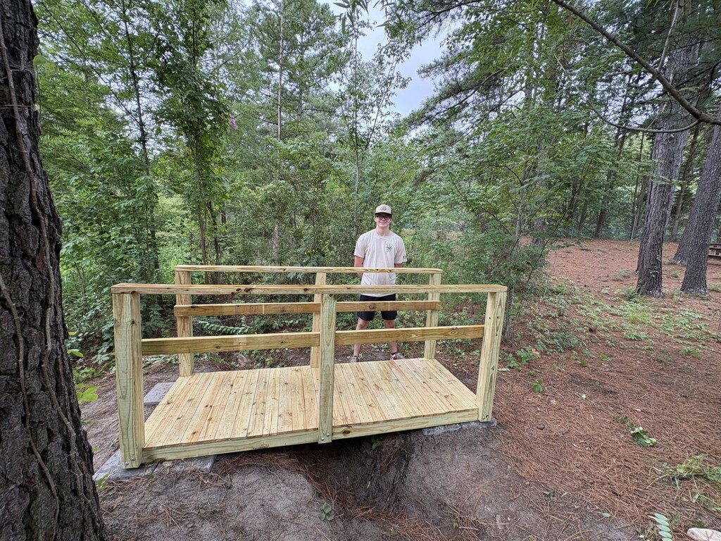 Michael Erwin standing on his completed bridge. 