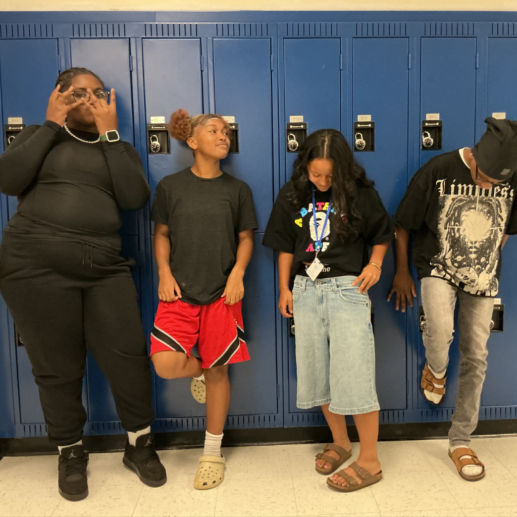 4 students posing in front of lockers