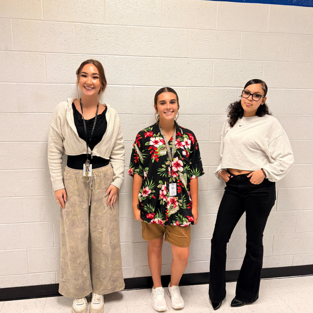A teacher dressed like a student and two students dressed like teachers
