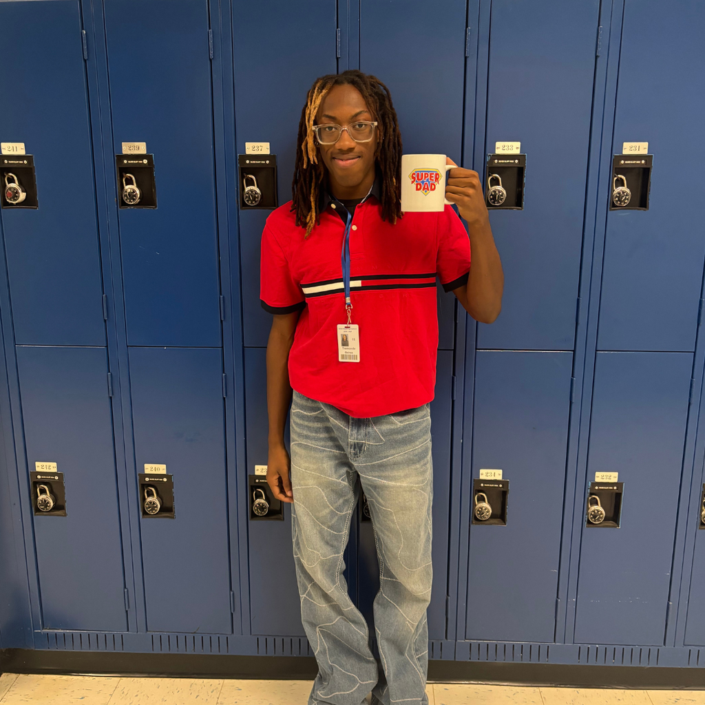 Student holding a coffee mug