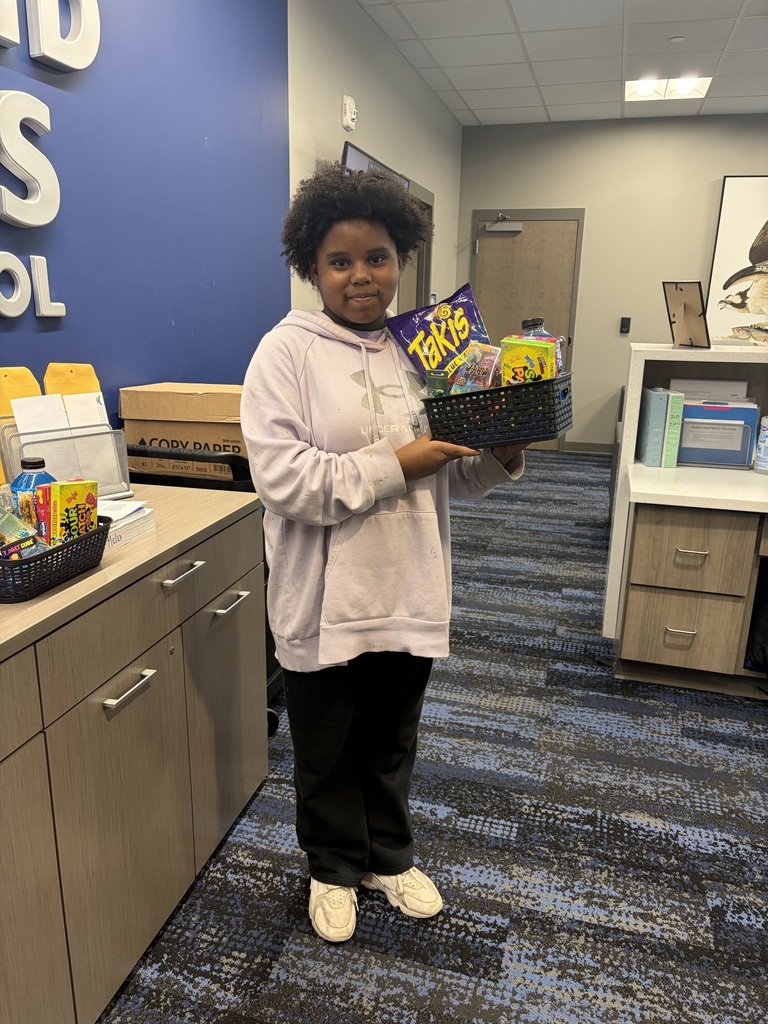 Student posing with gift basket