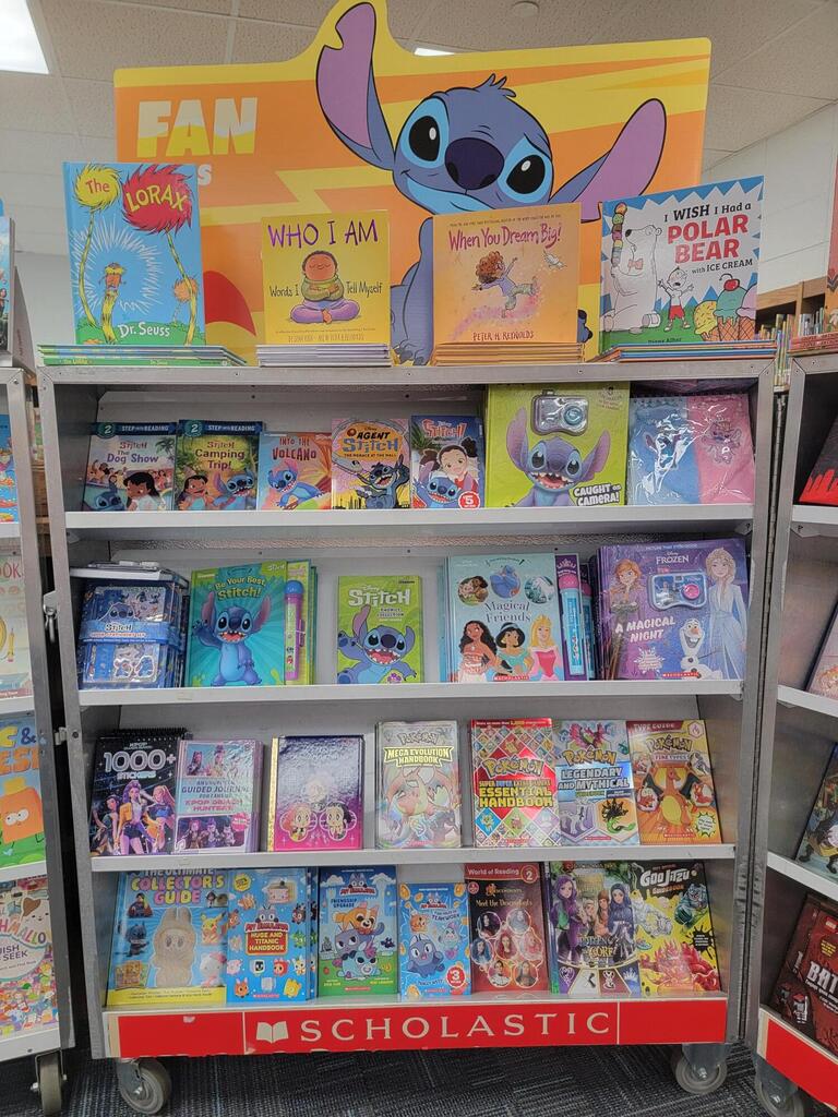 A bookshelf filled with children's books, including a top display with "Lilo & Stitch" and "Polar Bear."