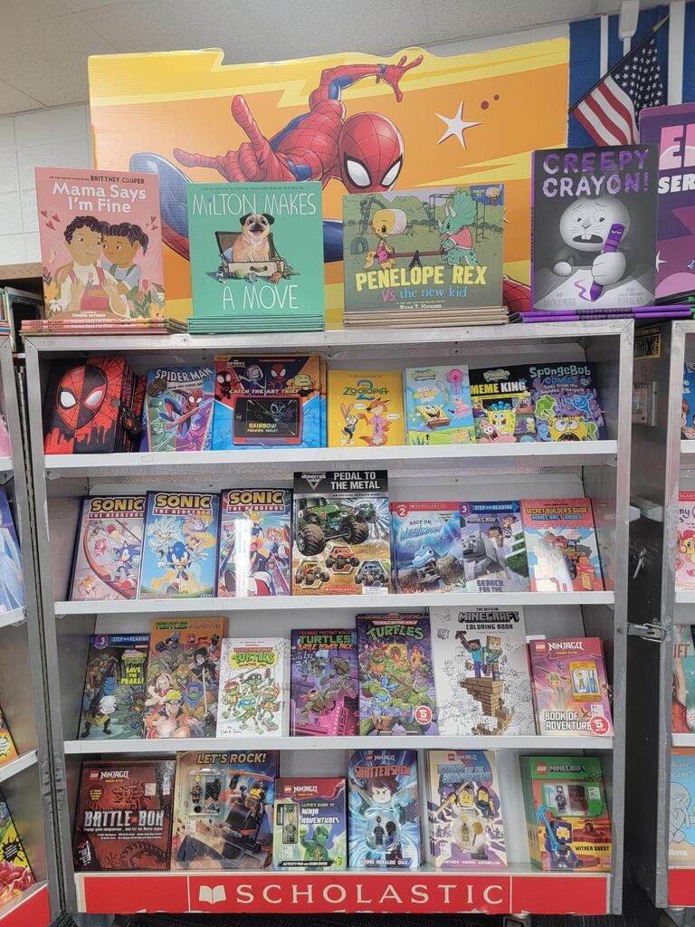 A library bookshelf with books on it. Titles include "Star Wars," "Spider-Man," and "Captain America."