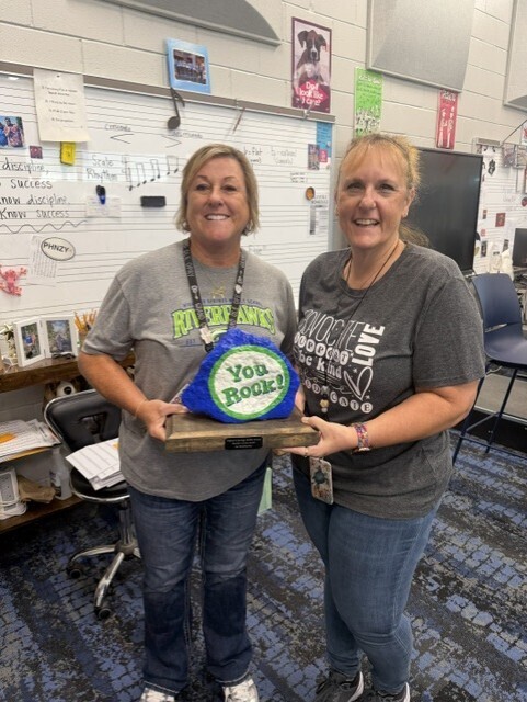 Mrs. Dewitt gives the You Rock award to Mrs. Bennett