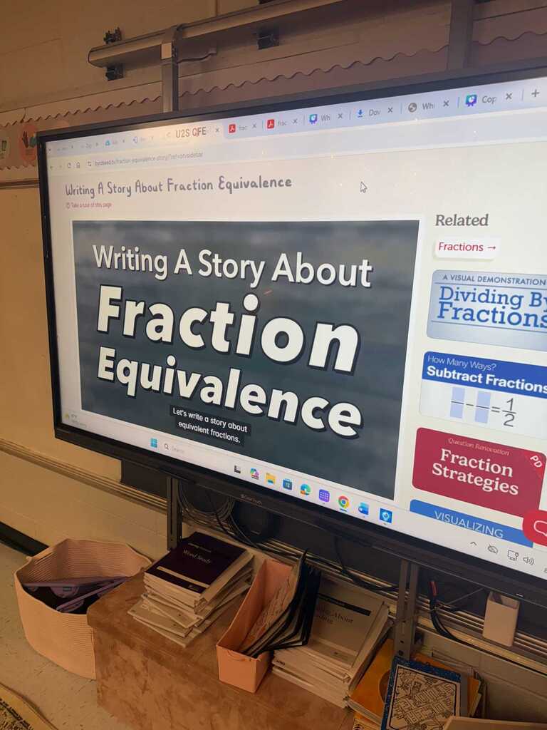 A computer monitor displays a lesson on fraction equivalence. The screen shows a title "Writing A Story About Fraction Equivalence."